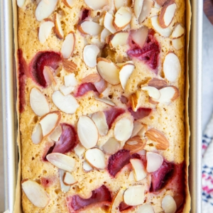 Loaf pan with almond flour strawberry bread inside, fresh out of the oven.