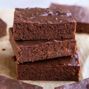 Stack of three protein brownies with other brownies to the side