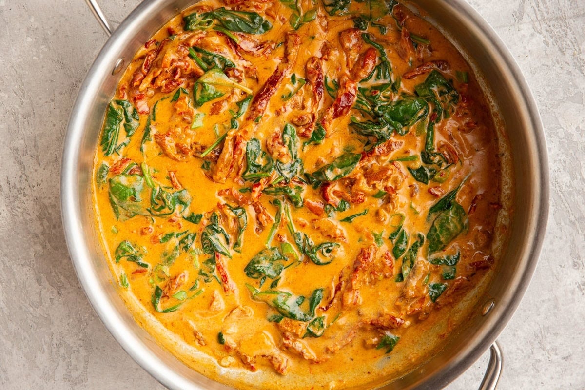 Skillet with sun-dried tomato sauce inside