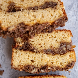 Loaf of cinnamon roll bread cut into individual slices, ready to eat.