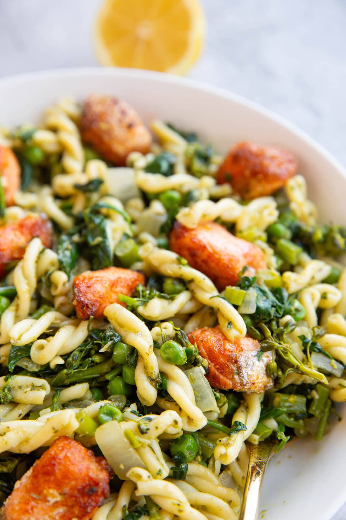 large bowl of salmon pasta with fresh vegetables.