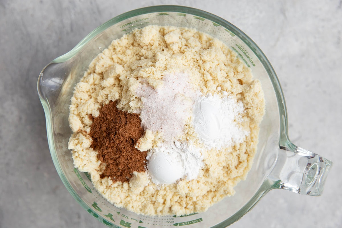 large measuring cup full of flour and dry ingredients for scones.