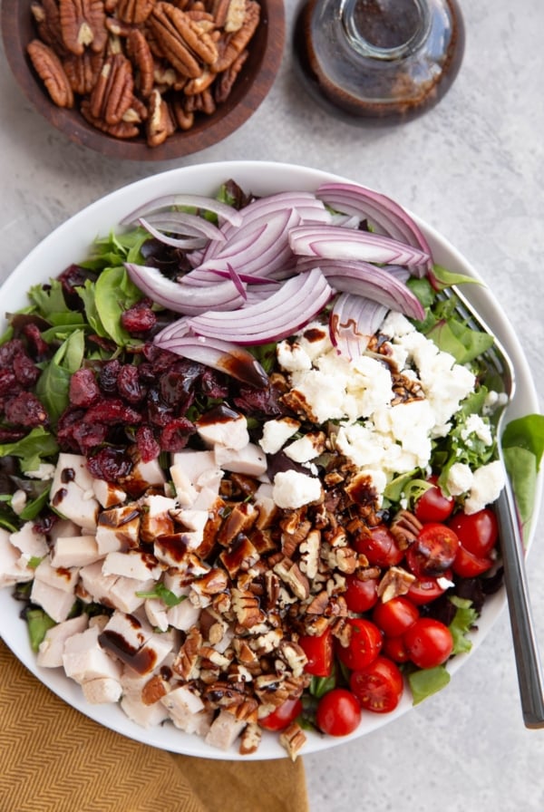 Large white bowl full of spring salad.
