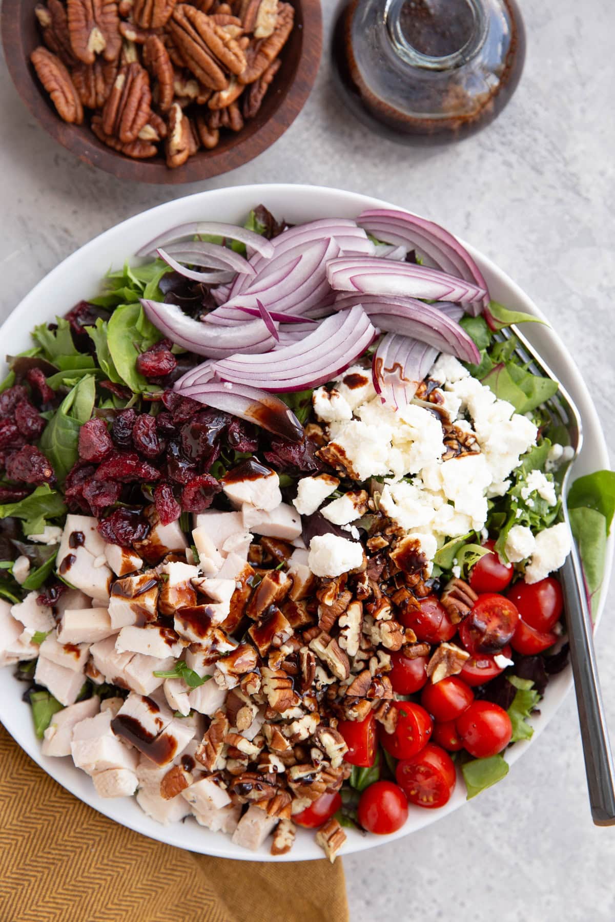 Large white bowl full of spring salad.