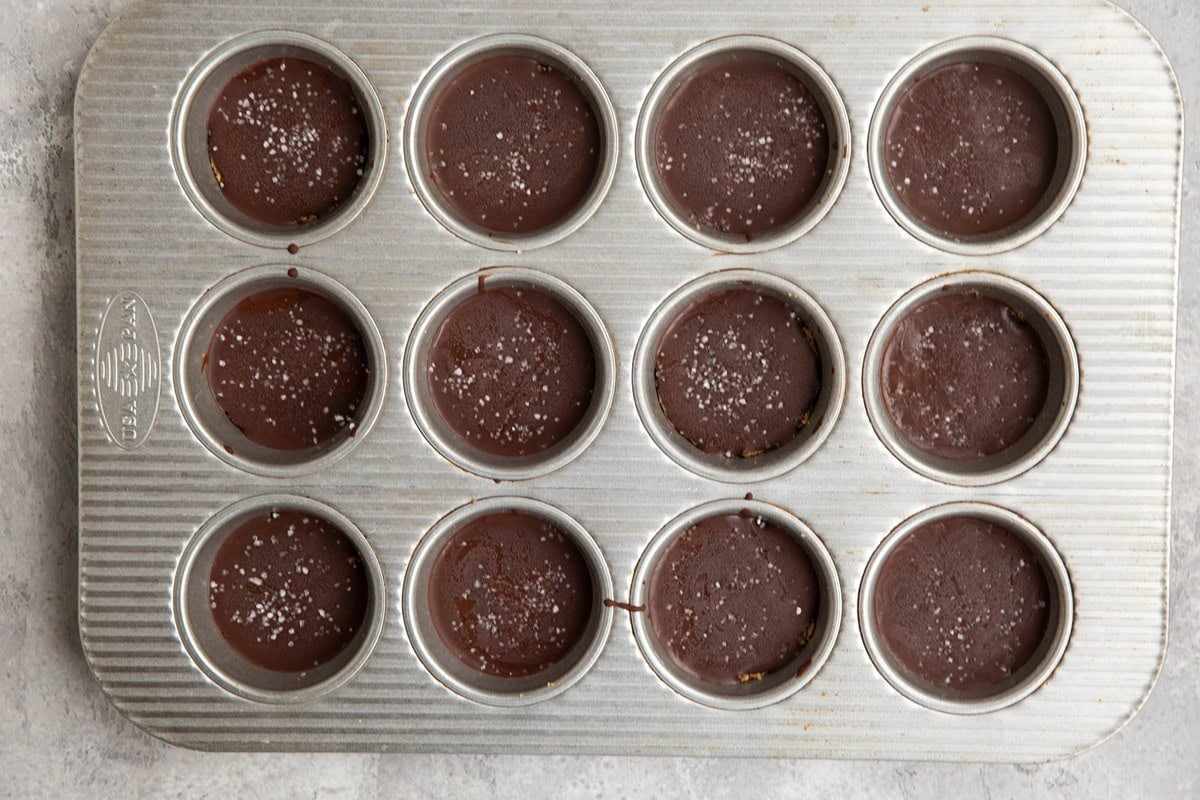 Muffin tin with chocolate covered protein energy bites inside, ready to serve.
