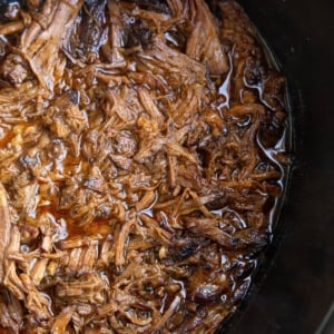 Shredded Korean BBQ beef in a slow cooker, ready to serve.