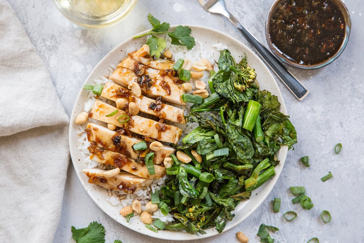 Vietnamese Lemongrass chicken on a plate with white rice and broccolini.