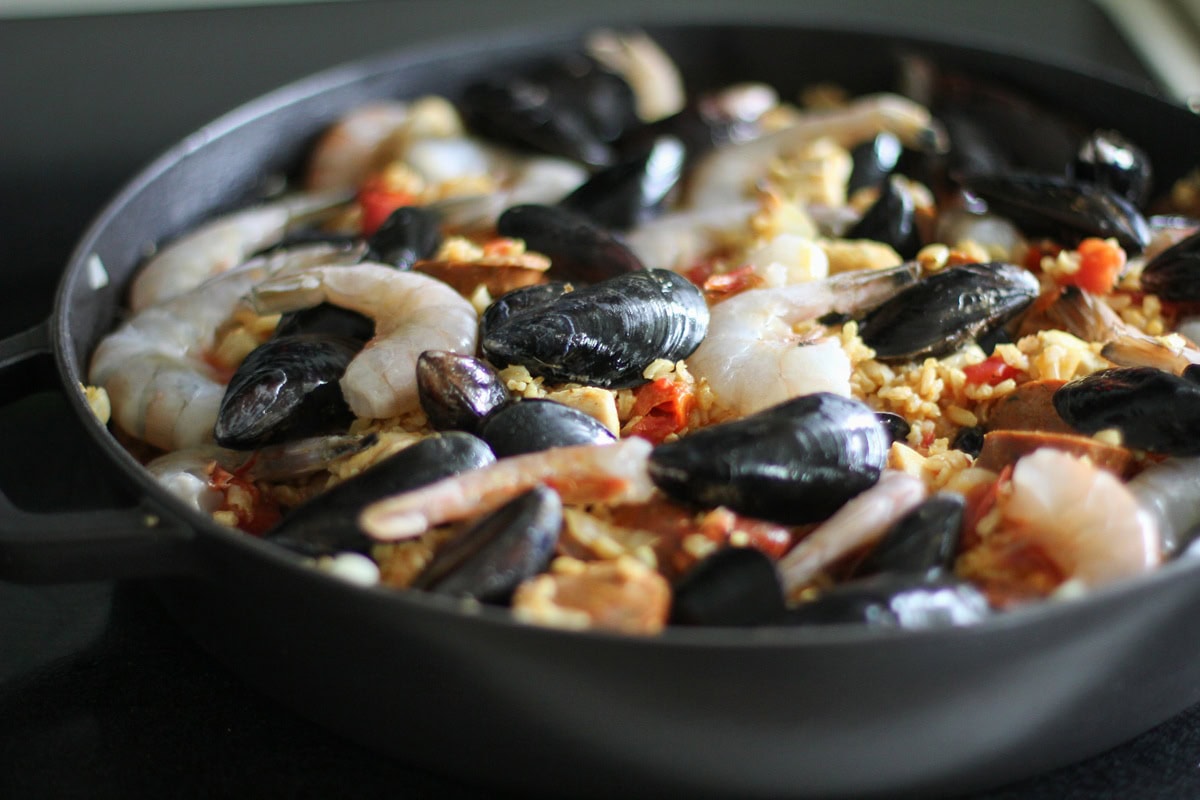 Raw seafood laid on top of rice to finish off the paella.