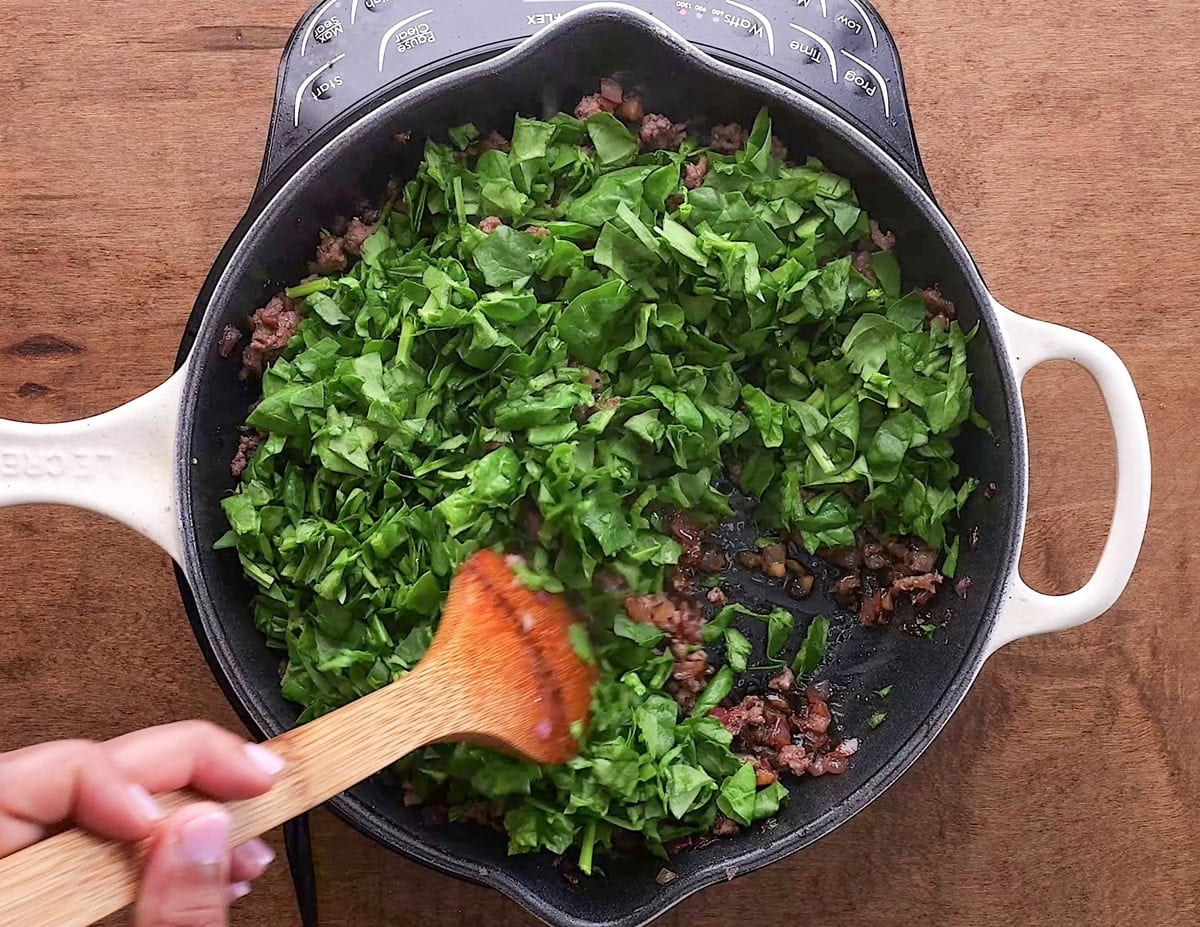 Spinach on top of meat mixture.
