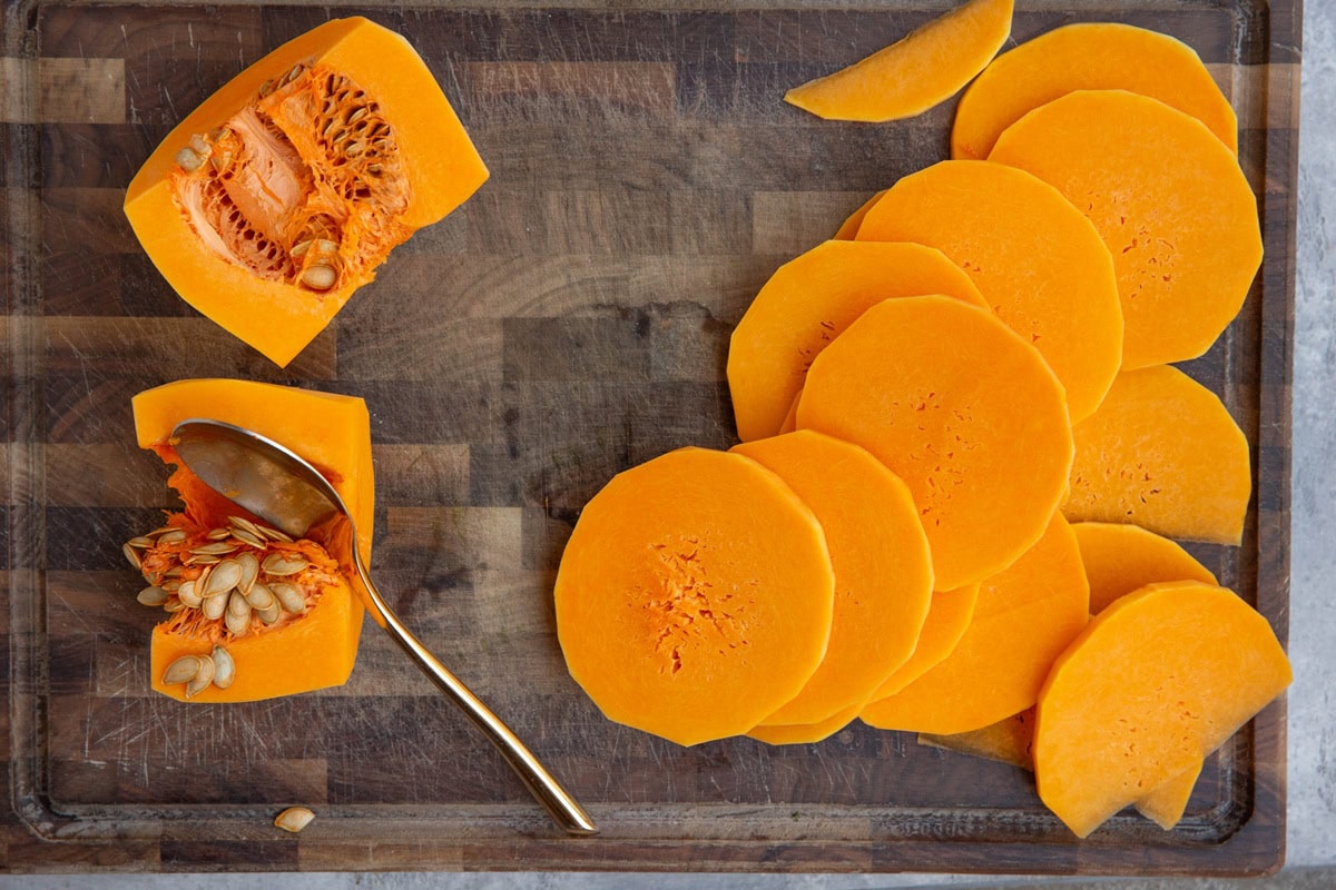 Sliced butternut squash on a wooden cutting board