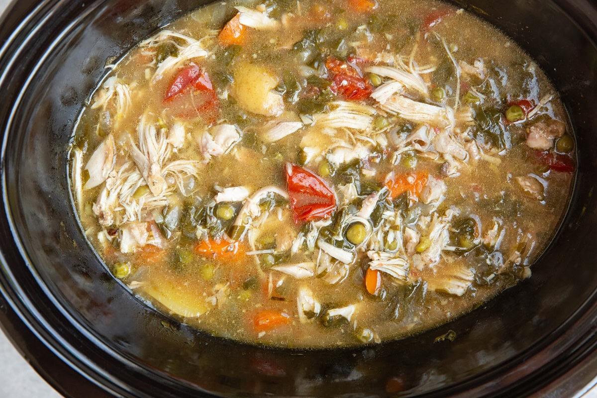 Slow cooker full of chicken stew, ready to serve.