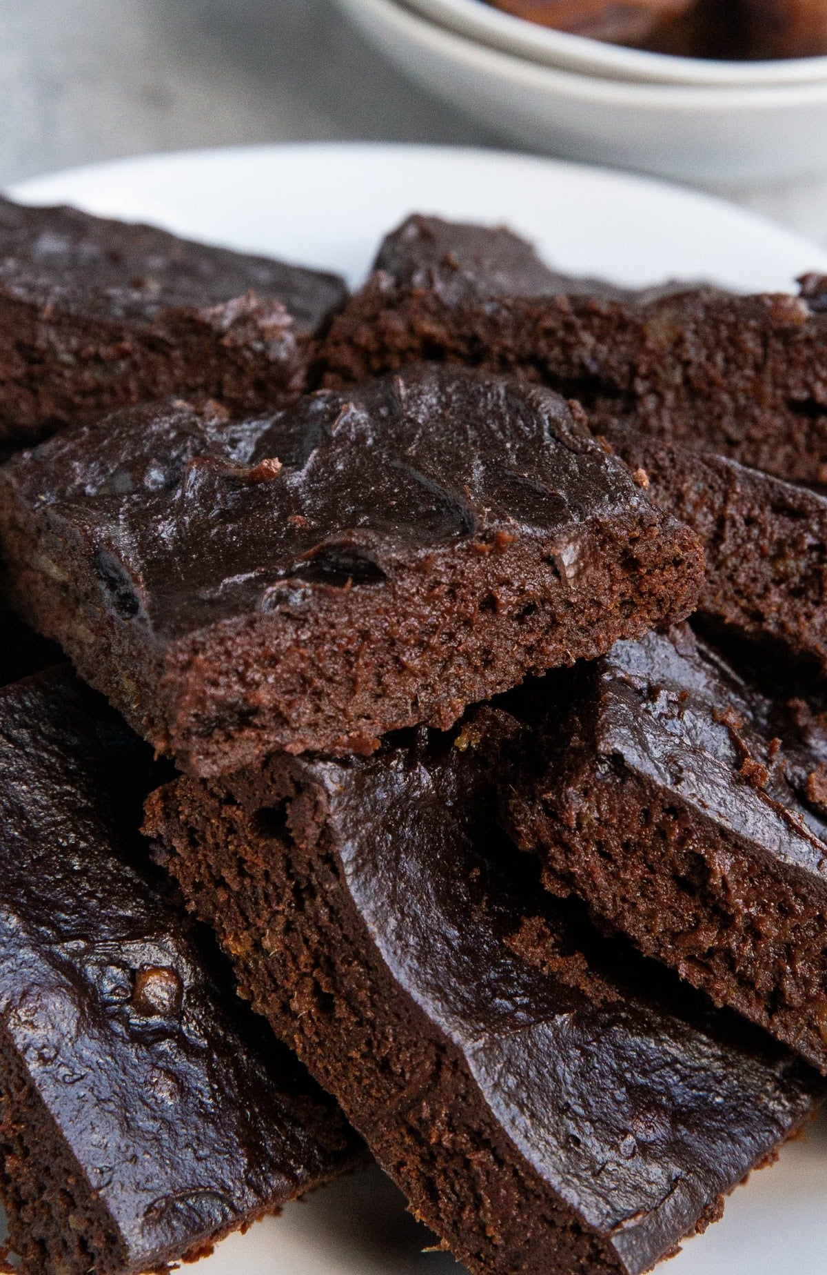 Date brownies stacked on top of each other on a plate.