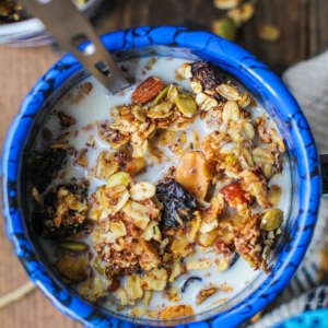 Bowl of granola with milk, ready to eat.