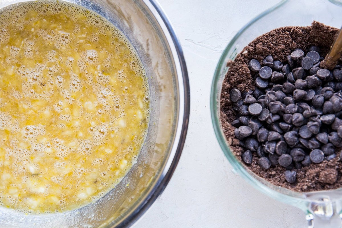 Bowl of wet ingredients mixed together and bowl of dry ingredients mixed together to make chocolate breakfast cake.