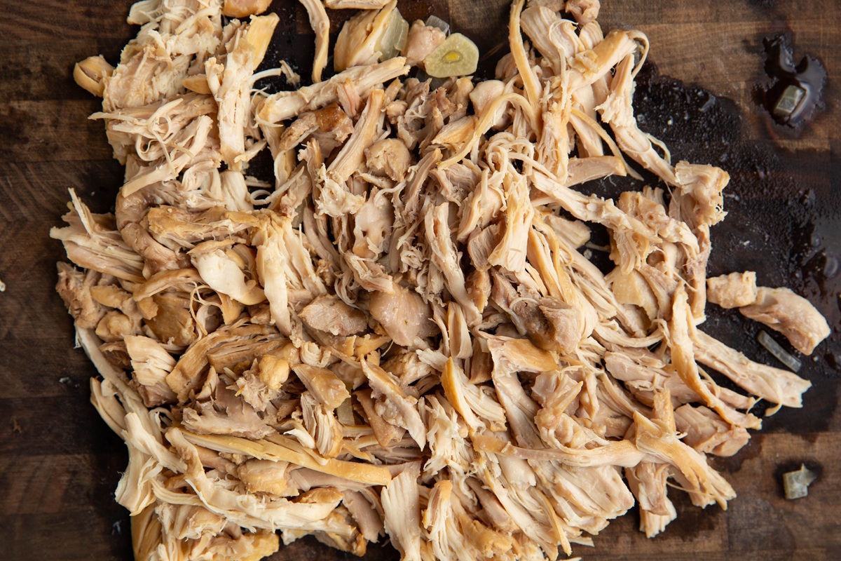 Shredded chicken on a cutting board.