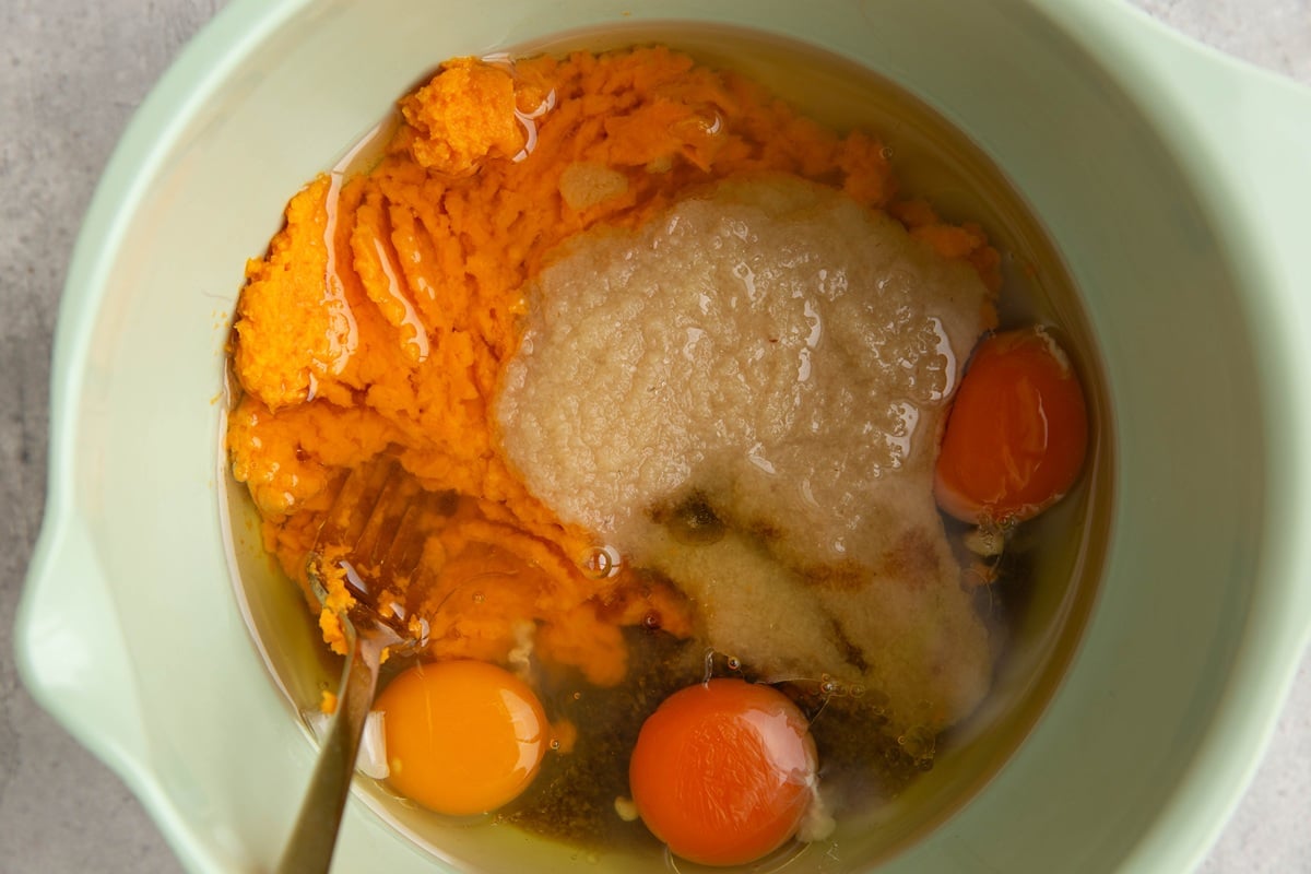 Mixing bowl full of wet ingredients to make sweet potato bread, ready to be mixed together.