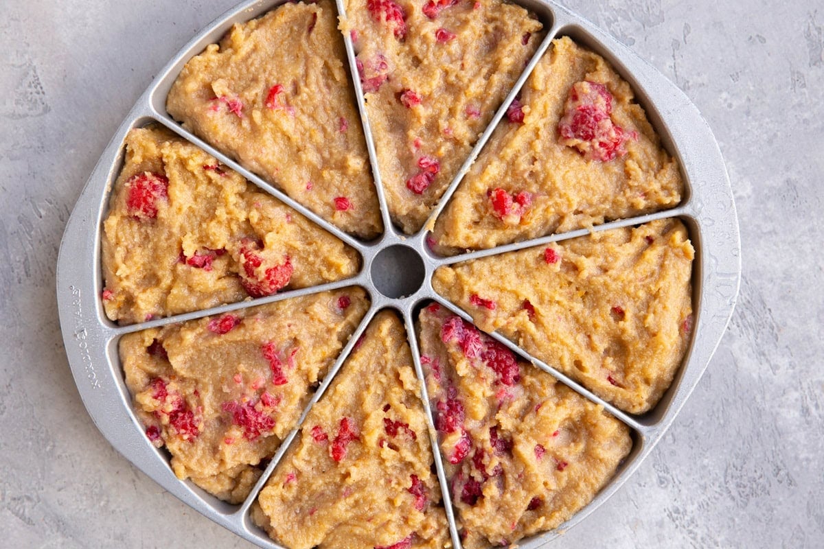 Scone pan with raspberry scone dough inside.