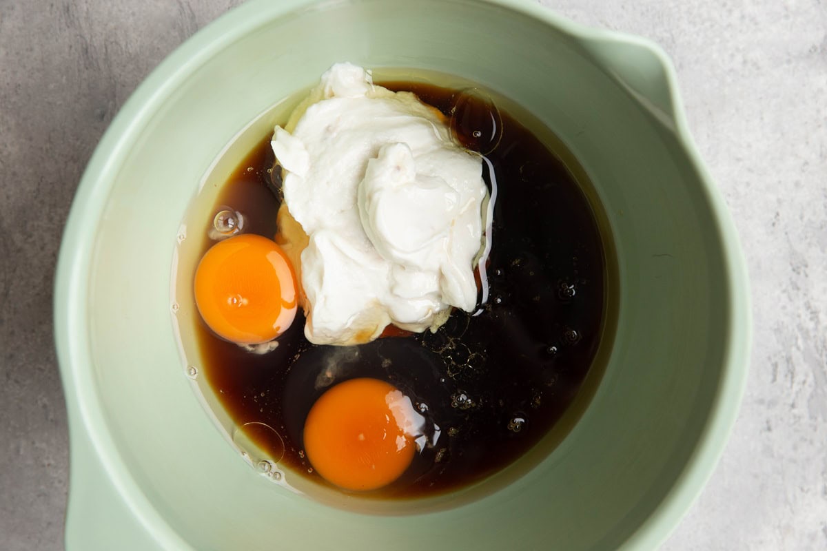Mixing bowl with eggs, pure maple syrup, and Greek yogurt.