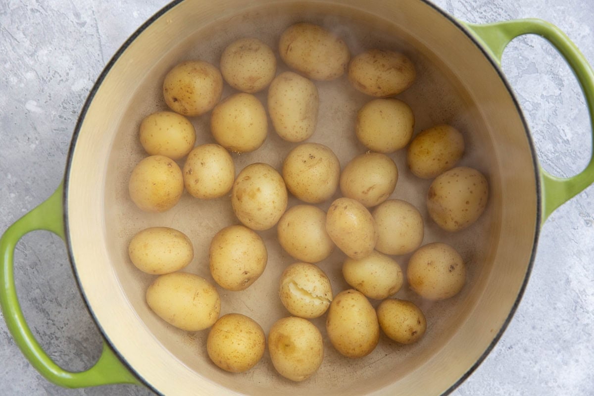 Boiled potatoes in a pot of water.