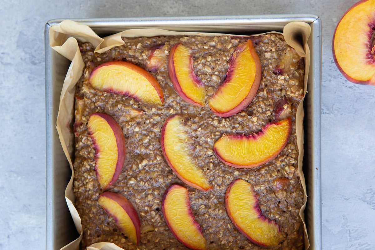Peach baked oatmeal in square baking dish, fresh out of the oven.
