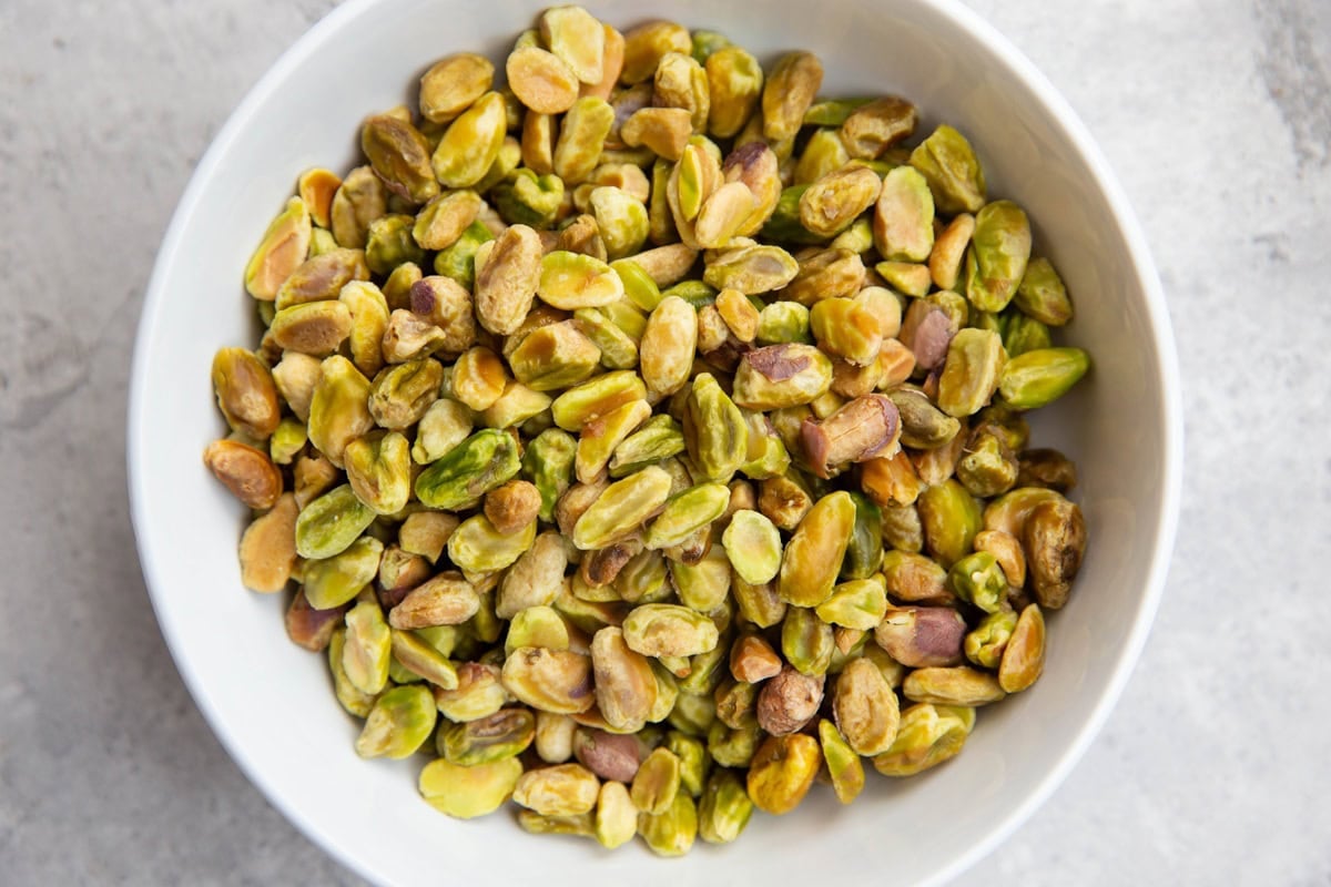 Raw peeled pistachios in a bowl to be used for pistachio ice cream.